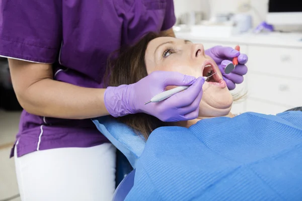 Patient With Mouth Open Being Examined By Dentist