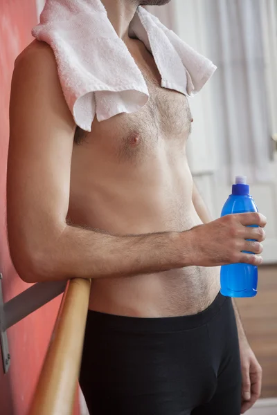 Midsection Of Shirtless Ballet Trainer Holding Waterbottle