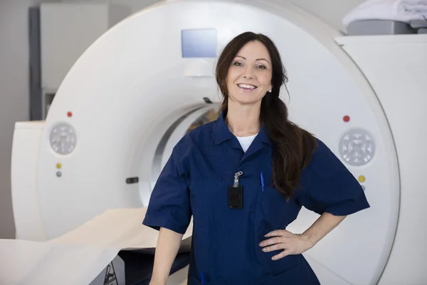 Confident Female Radiologist By MRI Machine