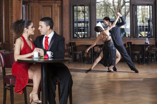 Loving couple and tango partners in cafe