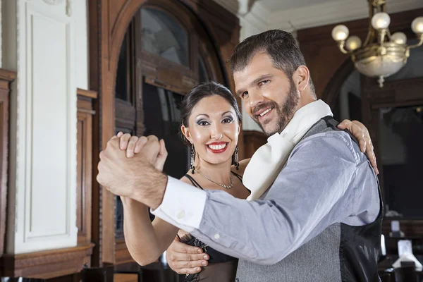 Portrait Of Happy Man And Woman Performing Tango In Restaurant