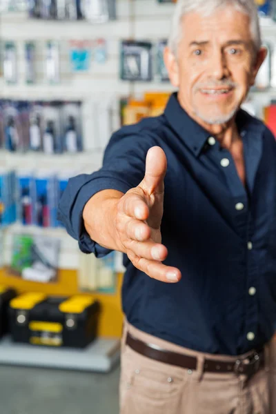 Man Gesturing Handshake In Hardware Store