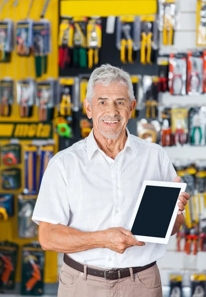 Man Displaying Digital Tablet In Hardware Store