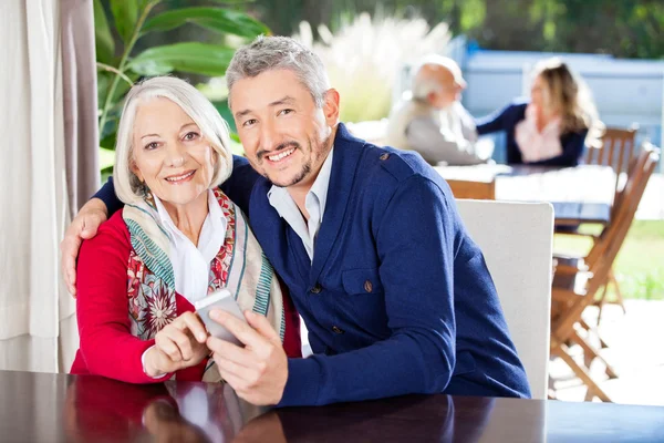 Portrait Of Family Using Smartphone At Nursing Home