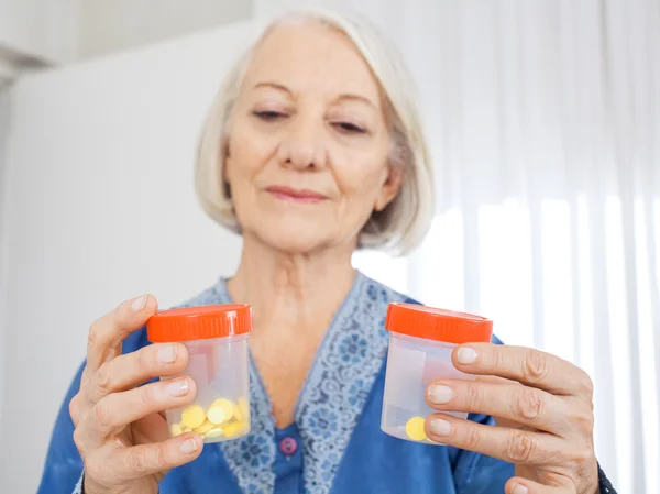 Senior Woman Looking At Pill Bottles