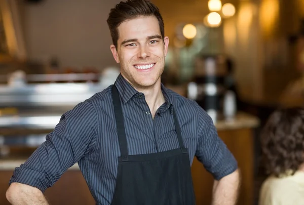 Happy Male Owner In Cafe