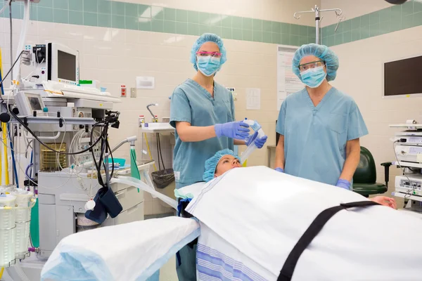 Nurses With Oxygen Mask Preparing Patient