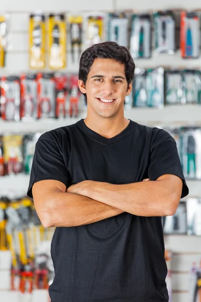 Man Standing Arms Crossed In Hardware Store