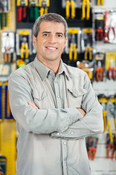 Happy Man Standing Arms Crossed In Hardware Store