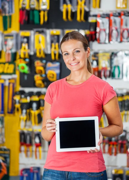 Woman Presenting Digital Tablet In Hardware Shop