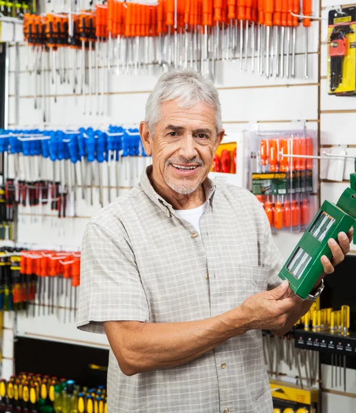 Customer Holding Packed Product In Hardware Shop