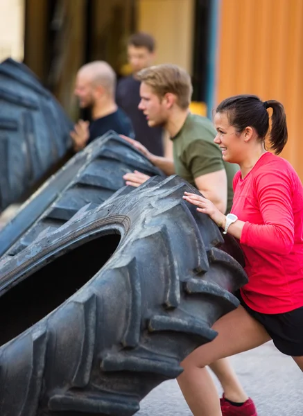 Determined Athletes Flipping Tire