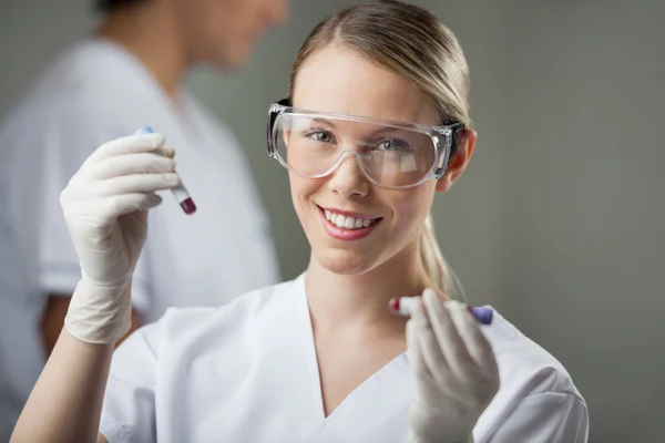 Technician Analyzing Blood Samples In Lab