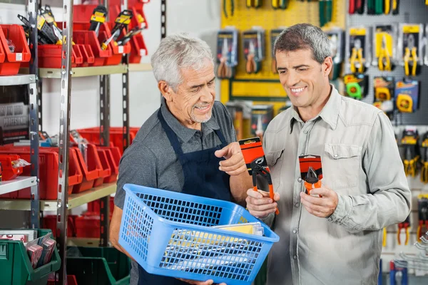 Salesman Assisting Customer In Buying Pliers