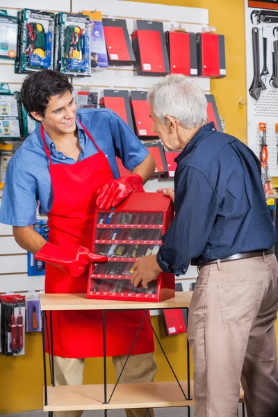 Salesman Showing Tools To Senior Man In Store