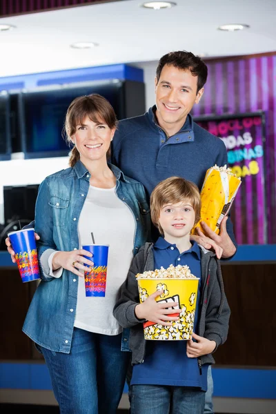 Family Holding Popcorns And Drinks At Cinema