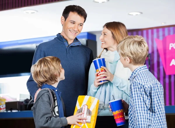 Family Having Snacks By Cinema Concession Stand