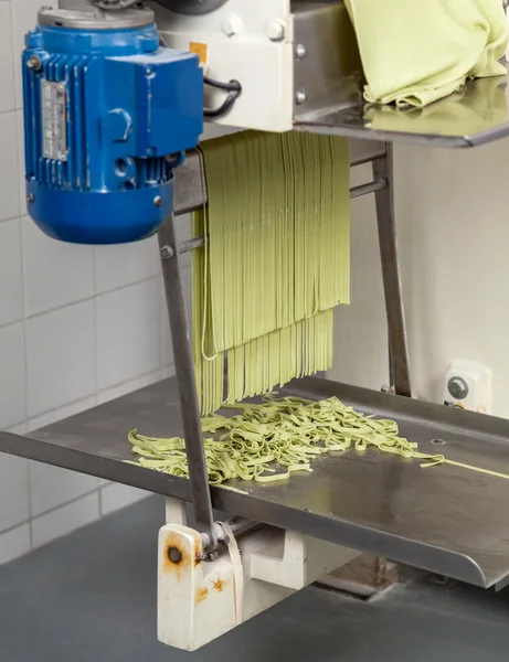 Green Spaghetti Pasta Being Processed In Machine