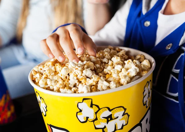 Girl Eating Popcorn In Cinema Theater