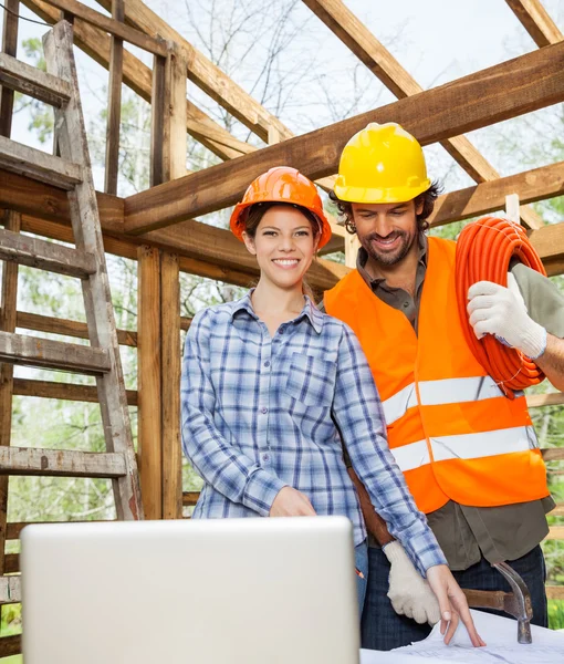 Architect Working With Construction Worker At Site