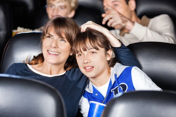 Mother And Daughter Watching Film In Theater