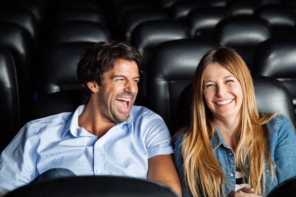 Couple Laughing While Watching Film In Theater