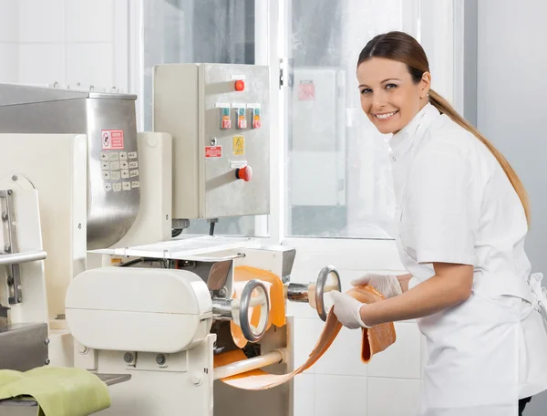 Female Chef Processing Spaghetti Pasta Sheet In Machine