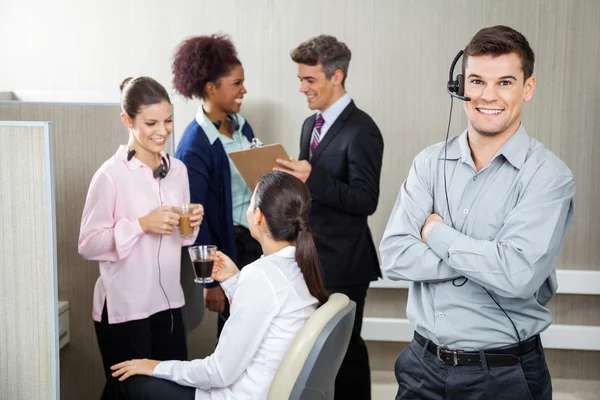 Smiling Customer Service Representative Standing Arms Crossed