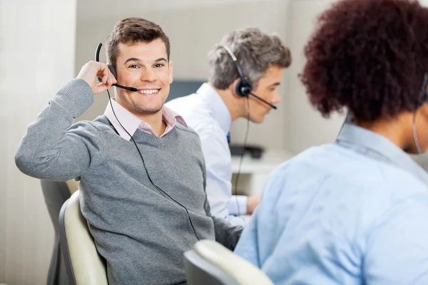 Male Customer Service Representative Using Headset In Office