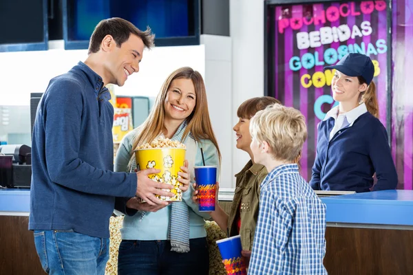 Happy Family Having Snacks At Cinema Concession Stand