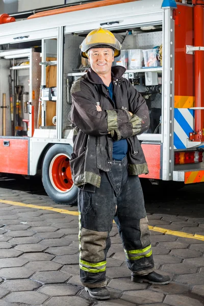 Happy Fireman Standing Against Truck