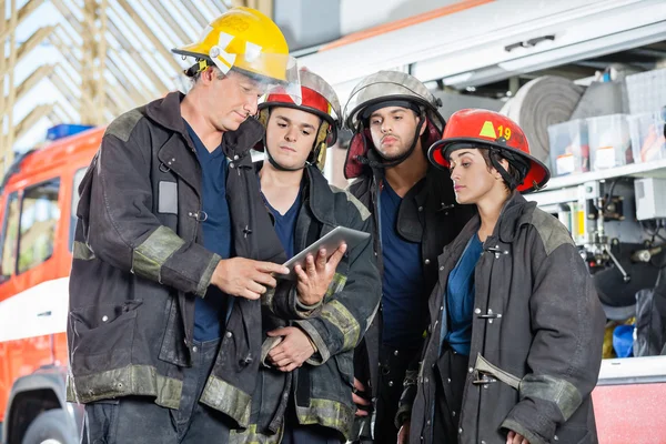 Team Of Firefighters Using Digital Tablet