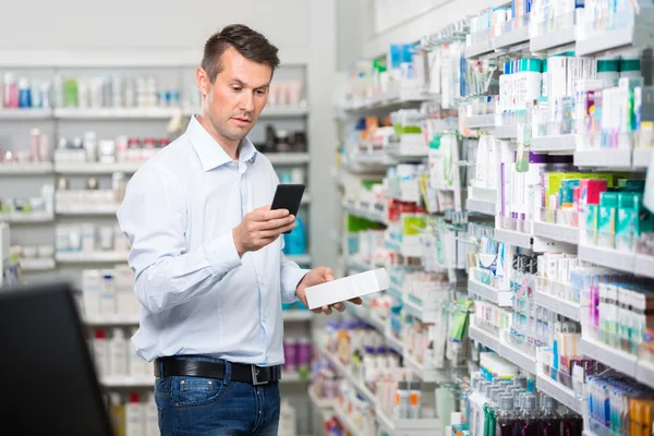 Consumer Checking Information On Mobile Phone In Pharmacy