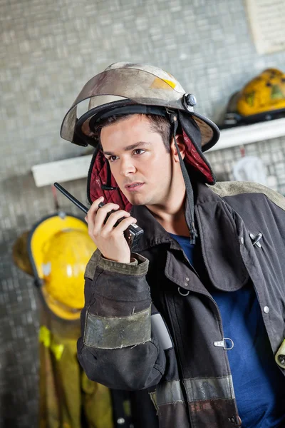 Confident Firefighter Using Walkie Talkie