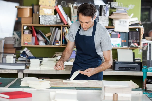 Worker Working At Table In Paper Industry