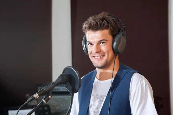 Smiling Young Male Singer In Recording Studio