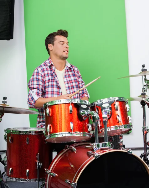 Male Professional Playing Drums In Recording Studio