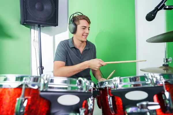 Male Professional Playing Drums In Recording Studio