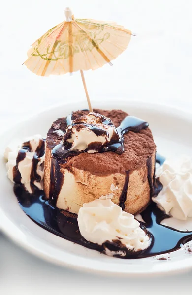 Tiramisu ice cream cake with cream and party decorations (shallow dof)