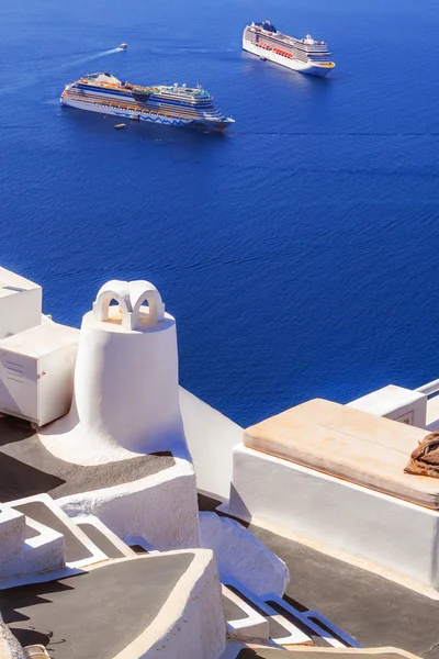 Imerovigli village architecture overlooking the cruise ships in the caldera, Santorini island, Greece