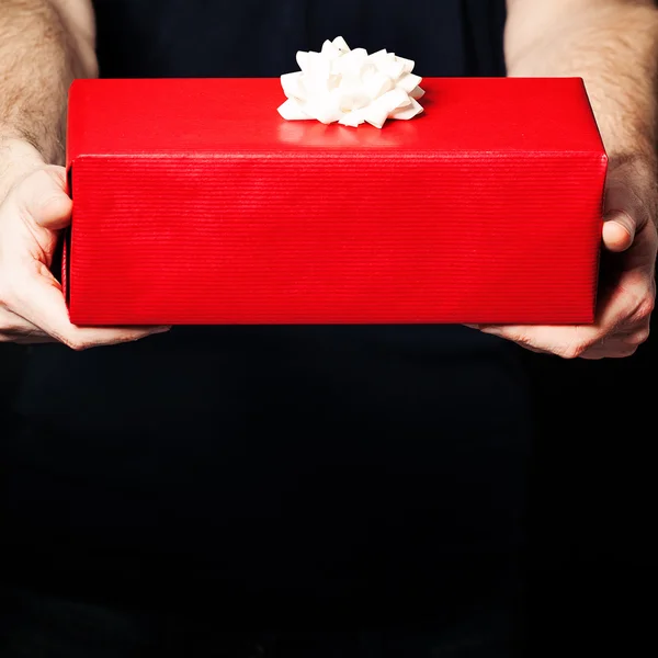 Gift Box and Male Hands on Black Background