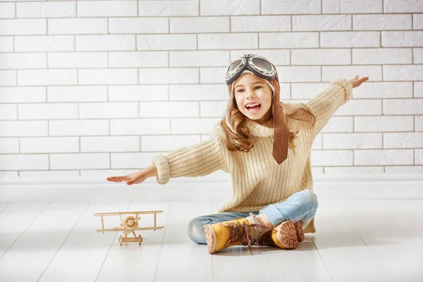 Girl playing with toy airplane