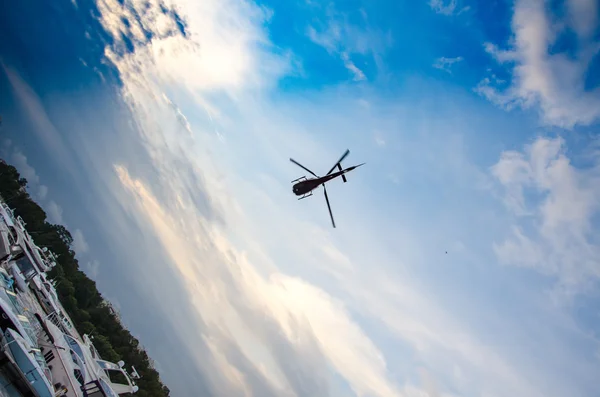 Helicopter in the sky with clouds