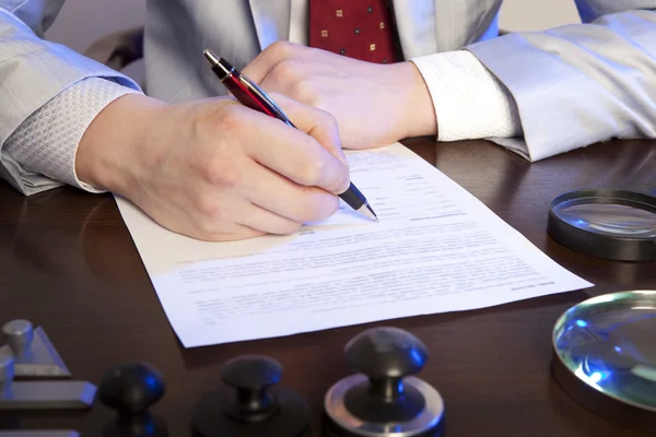 Notary signs the documents from our office