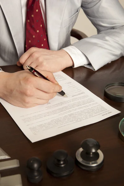 Notary signs the documents from our office