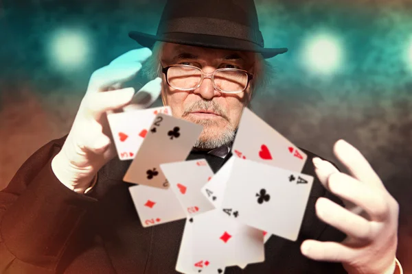 Magician show with playing cards.