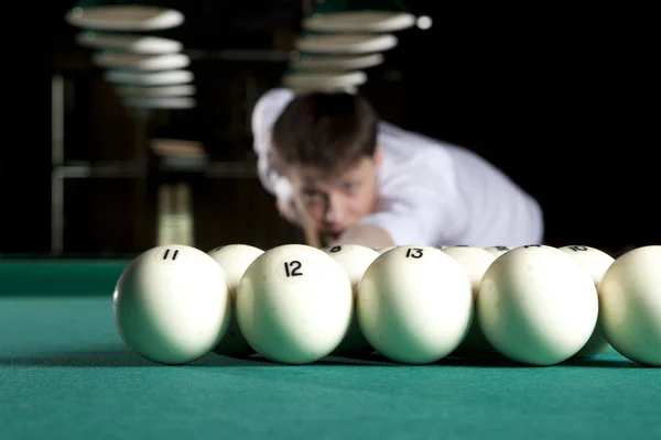 Young man playing billiards