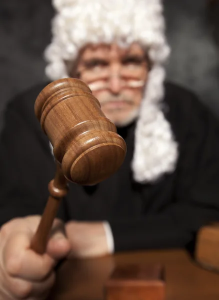 Senior judge in a courtroom striking the gavel