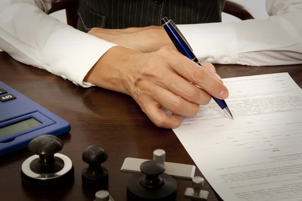 Notary signs the documents in office