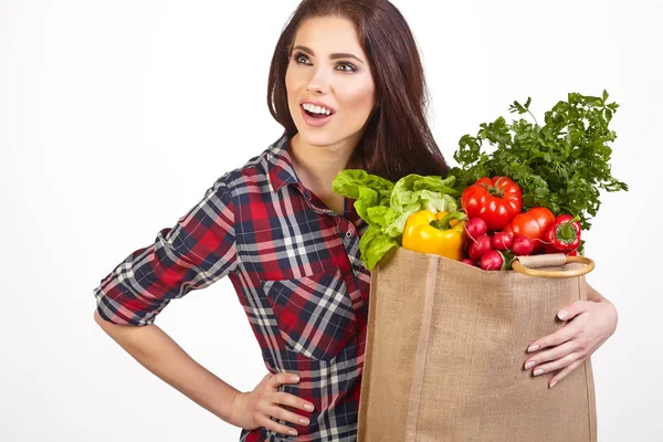 Woman with grocery bag and vegetables